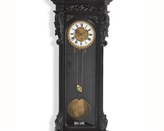 1036
A German Vienna Regulator Wall Clock
Circa 1890
Dial singed: Karl Suchy Sohne
The enameled metal dial with black Roman numeral hour markers and outer minute track centering a brass dore plaque with chased designs, and two train movement, set in a glazed ebonized wood case with carved floral and scrolling foliate motifs surmounted by urn finials
50" H x 17.5" W x 6" D
Estimate: $400 - $600