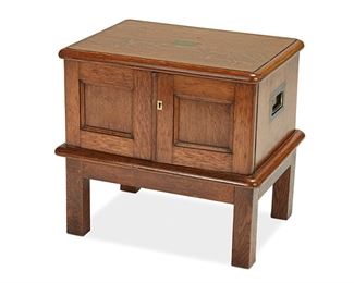 1049
An Oak Secretary Box
Circa 1899
With personalized plaque to top
The campaign-style oak secretary box with brass hardware and three felt-lined drawers inside cabinet doors raised on four legs
19.5" H x 21" W x 16.25" D
Estimate: $400 - $600