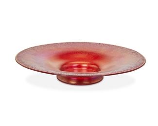 1053
A Tiffany-Style Art Glass Footed Plate
First-quarter 20th Century
The red art glass footed plate with onion skin edge
2" H x 12" Dia.
Estimate: $200 - $300