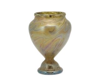 1054
A Loetz-Style Art Glass Vase
Late 19th/early 20th Century
Spurious mark to underside
The iridescent glass vase with pulled swirl motif in hues of green and blue with wide-shouldered body and flared foot
8.75" H x 6.25" Dia.
Estimate: $1,000 - $2,000