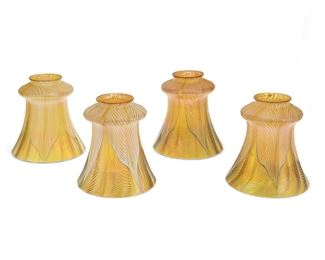 1055
Four Quezal Iridescent Art Glass Shades
First-quarter of 20th Century
Each signed: Quezal
Each gold iridescent bell-form glass with white and green pulled feather motif and iridescent interior with shades of green, 4 pieces
Each: 5" H x 5.125" Dia.; Fitter rims: 2.25" Dia.
Estimate: $600 - $800