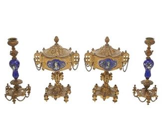 1099
A Pair Of Continental Gilt-Bronze Candlesticks And Garniture Urns
Late 19th/early 20th Century
Each gilt-bronze lidded urn with armorial and Gothic motifs centering a hand-painted, glazed ceramic portrait plaque, accompanied by a pair of conformingly decorated single-light candlesticks, 4 pieces
Each urn: 9" H x 6" W x 4.5" D; Each candlestick: 8.75" H x 3.5" Dia.
Estimate: $600 - $800