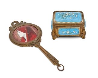 1100
Two French Limoges-Style Vanity Items
Late 19th/early 20th Century
Mirror signed: CB / d'apres [illegible]
Each gilt-bronze and enamel on copper, comprising a hand mirror with enamel portrait of a woman wearing a red shawl against a guilloche ground and a blue jewelry box with enamel floral decoration and velvet lined interior, 2 pieces
Mirror: 8.75" H x 4" W; Box: 2.5" H x 4" W x 2.5" D
Estimate: $300 - $500