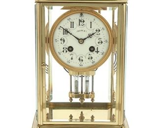 1104
A Samuel Marti Crystal Palace Regulator Clock
Fourth-quarter 19th Century
Dial marked: Tiffany & Co.; Movement marked: Made in France / Marti et Cie. / Medaille d'Argent / 1889
Retailed by Tiffany & Co., the French mantel clock with painted porcelain dial with black Arabic numeral hour markers and outer minute track enclosed in a gilt-bronze bezel, with time and strike 8-day two train movement, and mercury pendulum, set in a glazed brass case with beveled glass panels
10.75" H x 7" W x 5.375" D
Estimate: $300 - $500