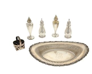 1112
A Group Of Silver Table Items
20th Century
Each with various maker's marks; Two marked for silver plate; Four marked for sterling
Each variously patterned, comprising an International oval serving dish (2" H x 12" W x 8" D), two International "Prelude" salt and pepper shakers (each: 5" H), two silver plate salt and pepper shakers (each: 5.875" H), and one Cartier woven basket (3" H x 2.5" W x 2.25" D), 6 pieces
Weighable sterling: 17.245 oz. troy approximately
Estimate: $400 - $600
