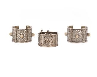 1113
Three North African Metal Bracelets
20th Century
Each with openwork designs, comprising two cuffs with carved bone points and one hinged cuff, 3 pieces
Larger: 10" C x 2.375" W; Smaller: 8.75" C x 1.875" W
553.7 grams
Estimate: $25 - $50
