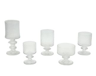 1126
A Set Of "Senaattori" Glassware By Timo Sarpaneva For Iittala Of Finland
Circa 1960s-70s
Seven with etched mark: TS
Each molded glass with ice-motif texture, comprising seven large water goblets (7.75" H), three red wine glasses (5.75" H), three white wine glasses (5" H), six sherry/port glasses (4.375" H), and six dessert/coupe glasses (3.75" H), 25 pieces
Estimate: $300 - $400