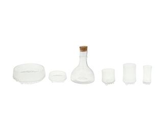 1127
A Group Of "Ultima Thule" Glassware By Tapio Wirkkala For Iittala Of Finland
Circa 1960s-70s
Each with an ice and snow inspired motif, comprising a carafe with cork stopper (8.5" H x 6" Dia.), three highball glasses (5" H), six lowball/rocks glasses (3.5" H), three sparkling wine glasses (4.5" H), one large bowl (3.5" H x 7.75" Dia.), and one small dish (2" H x 4.5" Dia.), 15 pieces
Estimate: $200 - $300