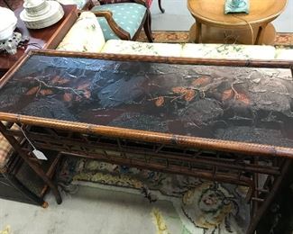 Beautiful bamboo style table with design on top.