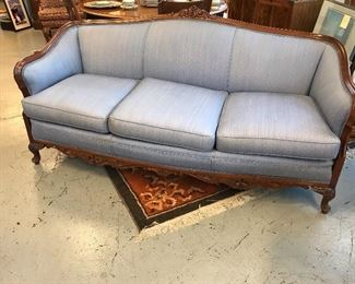 Nice 3 cushion carved couch.  Probably from the 1940's.  One leg needs attention.