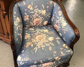 Love this little overstuffed chair.  Beautiful carving and look at the feet.