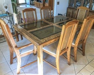 Wood Dining Room Table w/Beveled Glass and Cane Inserts includes (2)~18" Leaves & 6 Chairs ~ $165.00 Table w/out leaves ~ 30" H x 60" W x 39.5" D             Chairs ~ 41" H x 22" W x 20" D 