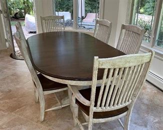 Canadian made walnut and antiqued French farmhouse table with double pedestal and six antiqued mission style chairs. Excellent used condition. Table is 53 inches long and comes with 2 18”inch leafs.