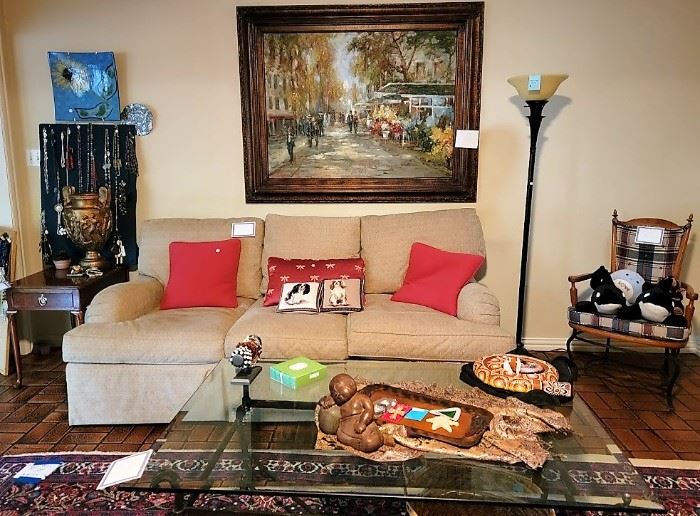 Comfortable living room den:  glass and iron coffee table, wood and iron chair, standing lamp, huge European scene art, Baker side table, neutral comfy sofa
