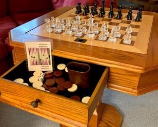 Oak chess & backgammon table, with pieces.    Dominate loved ones while playing Queens Gambit in your home.