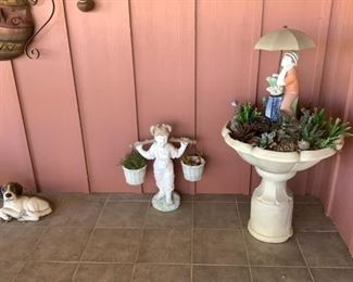 Outdoor water fountain lots of garden items and plant material