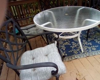 Outdoor glass top table 4 foot diam.  For chairs. 