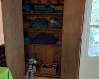 Antique 'cowboy' armoire from Dodge City. Used as a closet in the 1800's. Shelves were added and most recently used for fine china and glassware. 
Many sheet sets.