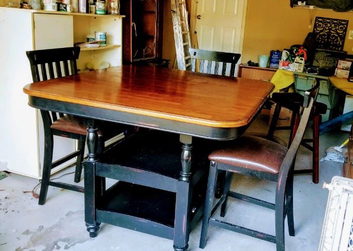 Bistro height table with 2 shelves. Includes 4 chairs and 2 stools.  It is 4'x4' but easily expands to 4'x6' with 2 hidden leaves. 