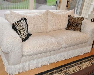 Two-Cushion Sofa with White on Beige Tapestry Upholstery,  Rolled Arms, and Fringe. 88'W x 33"H x 41"D
