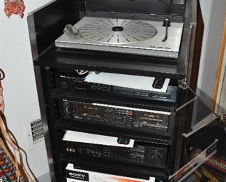 5-Shelf Stereo Cabinet. Bang & Olufsen Turn Table. Yamaha Natural Sound System Stereo Tuner T420, Cassette Deck K-222, and Amplifier AVC 50. Sony DVD Player, DVP-SR200P.  NEC 4-Head HQ Hi-Fi