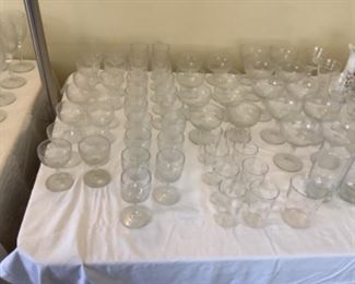 Multiple sets of vintage glassware and stemware.