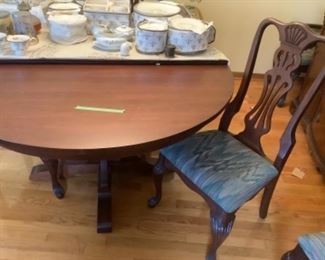 Solid mahogany round table  (54”) with four leaves (12” each) six chairs and table pads.  Presale $350 