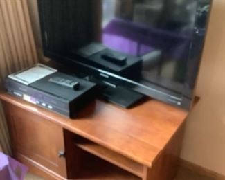 Flatscreen TVs and tv stand.