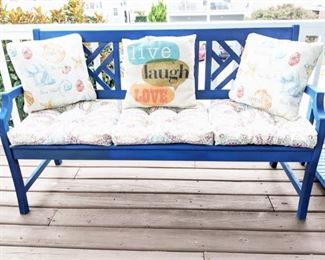 Wooden three seater bench with cushions