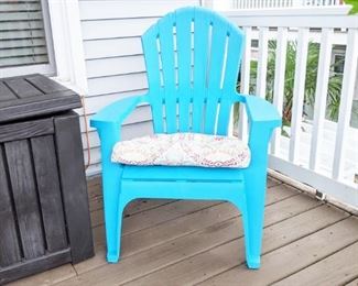 One of a pair of outdoor adirondack chairs