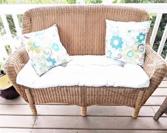 Outdoor wicker loveseat and pad