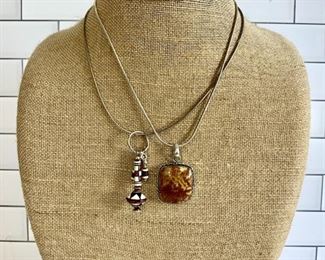 Sterling Silver Necklace With Dangling Pendant & Silver Necklace And Carmel Pendant
Lot #: 32