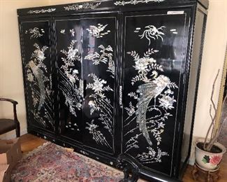 8.5 ft long armoire . Black lacquer and mop abalone inlay