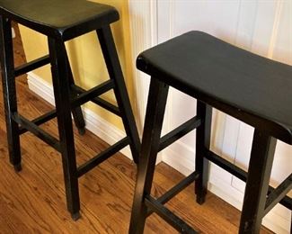 Two matching black bar stools