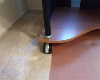 The office desk has wheels for easier maneuvering. The wheels do have a lock.