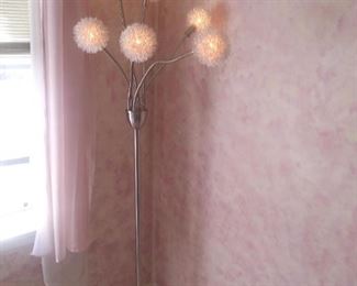 This adorable floor lamp is dimmable and it also includes a step button for on/off functions.  It is connected to an of/off wall switch.