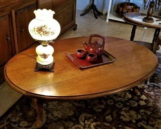 All wood oval coffee table with sides up. Vintage lamps for sale too.