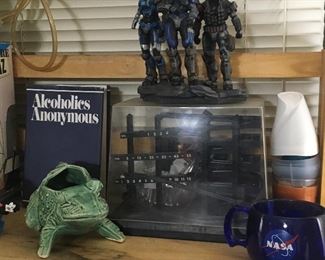 Halo figures statue, a crazy ball based clock, a McCoy frog planter...