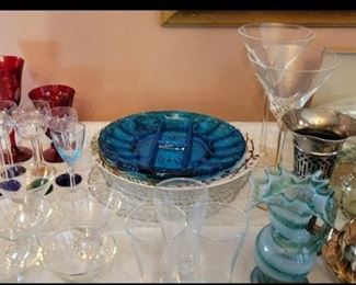 Lots of beautiful glass serving dishes and stemware. 