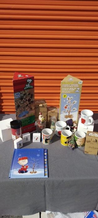Jim Shore Santas and Peanuts Hallmark items plus Charlie Browns Christmas Trees in box