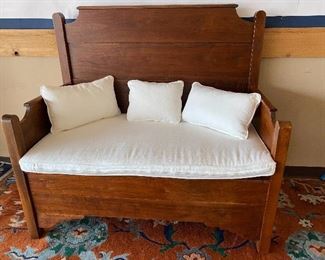 This bench was made from a 3/4 bed. It has ample storage and was professionally refinished and comes with new cushions! 
