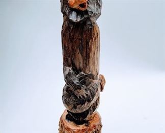 Carved bear with a charming smirk.  