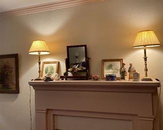 Small shaving mirror with a pair of sweet pictures and lamps.