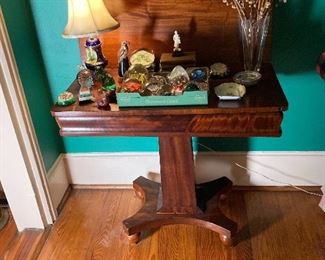 Elegant game table with a wonderful collection of paperweights.