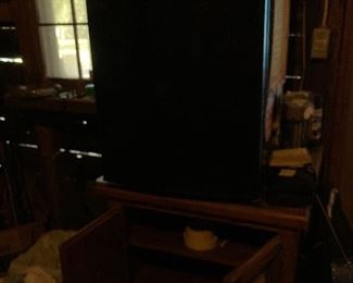 Impossible to see but a mini refrigerator sitting on a great storage cabinet.