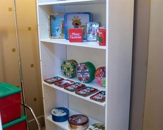 Tins, baskets, etc.  Christmas ornament storage boxes on the left.