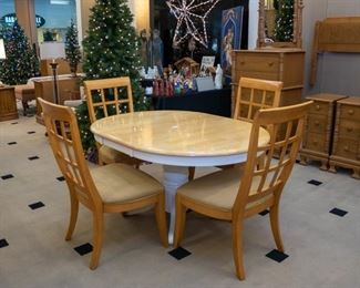 Table with fold-able storage leaf - reverts to round.  4 very nice chairs - sold separately.
