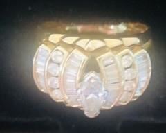 Approx . 2 carat total weight Diamond ring with approx 1/2 Ct Total weight in The Center Diamond is a 3/4 Carat Marquis Cut Diamond with 8 Round Brilliant Cut diamonds & and 30 Tapered Baquette cut diamonds . It weighs 12 Grams of 14 K Yellow Gold and is a size 11 . It can be resized . There are 3 bands soldered together.