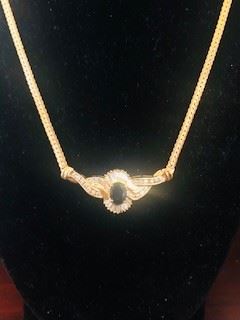 14k gold necklace is 18 in long and weighs 9.5 grams There are 22 round brilliant cut diamonds and 20 Baguette cut diamonds. The deep blue Oval Cut  sapphire measures approx 8mm x 6 mm ( 1.8 ct )