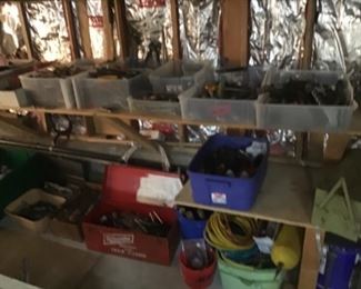 Bins of screw drivers wrenches air compressor stuff
